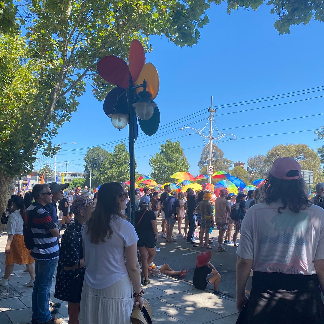 2024 pride march 4/2 - colourful umbrellas and people watching the parade