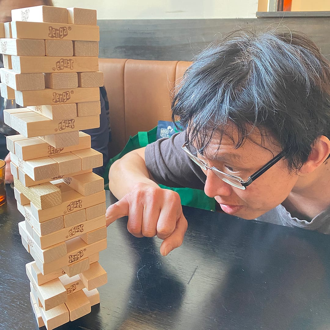 playing jenga at bobby peels as 2022 afl grand final plays on