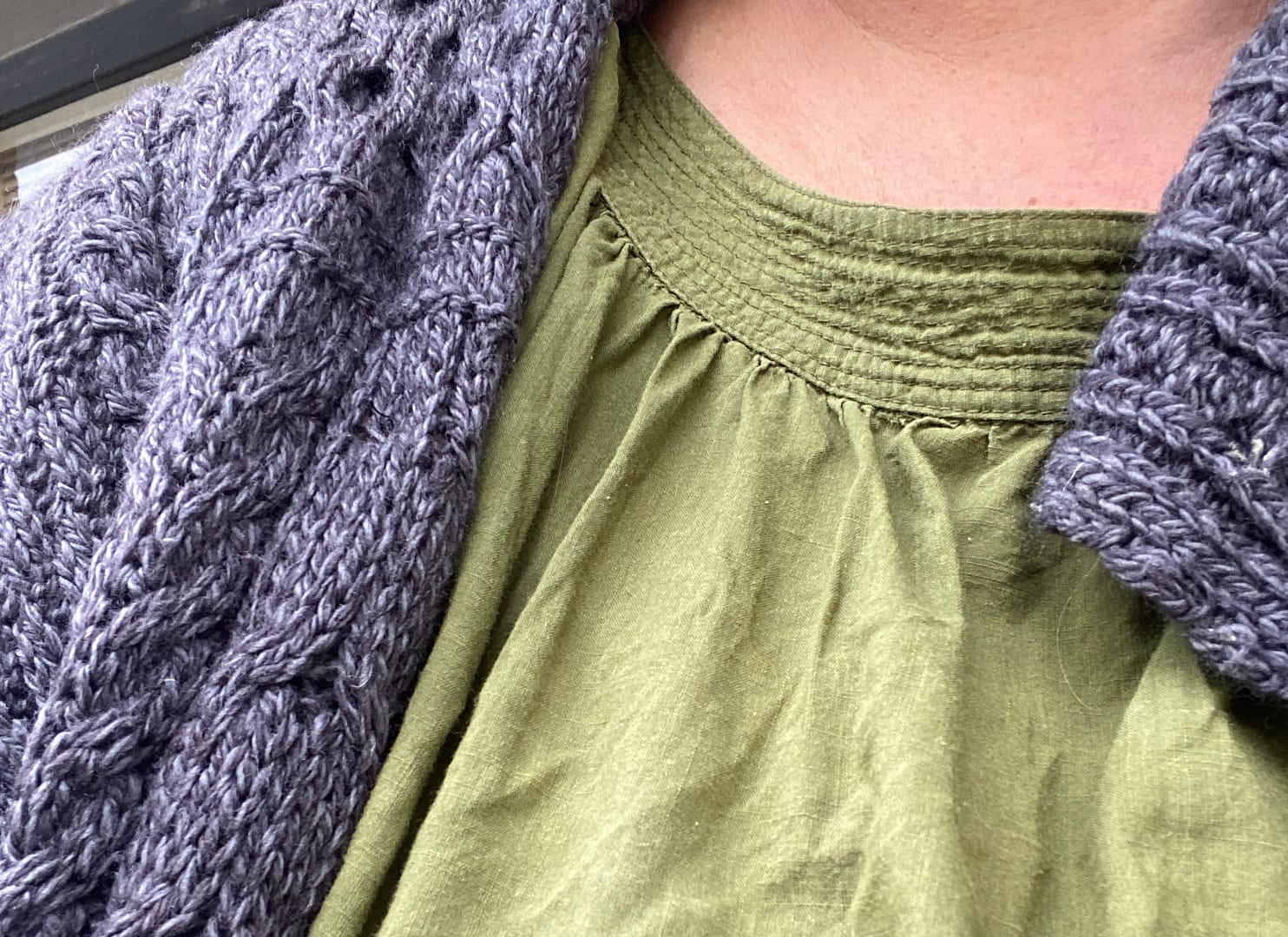 woollen jumper and green cotton shirt detail