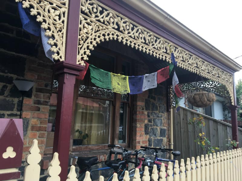 peace flags, bikes, picket fence, brick house frontage