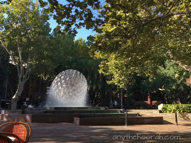 water fountain and sunshine and leaves and blue sky in kings cross
